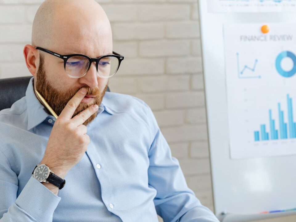 Financial professional reviewing business performance charts and financial reports during a financial planning session