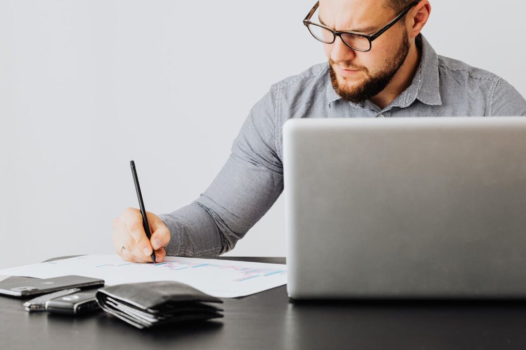 Business professional reviewing financial reports and accounting data on a laptop for small business financial management
