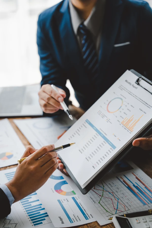 Fractional controller reviewing financial performance reports with business client